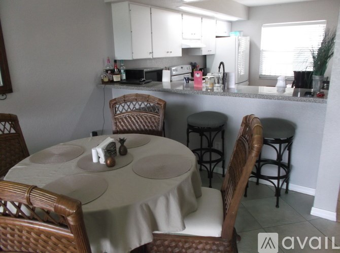 A kitchen with a table and chairs in the foreground.