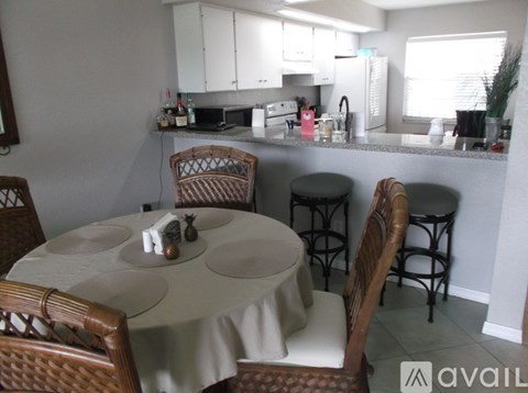 A kitchen with a table and chairs in the foreground.