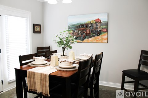 A kitchen with black cabinets and a granite countertop.