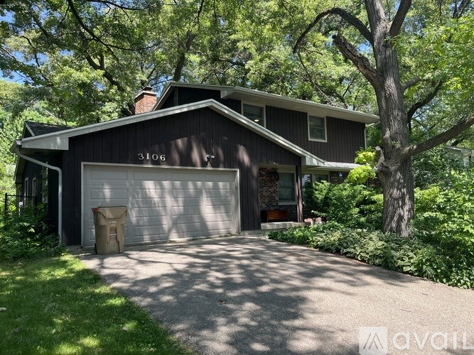A house numbered 3106 is surrounded by greenery.