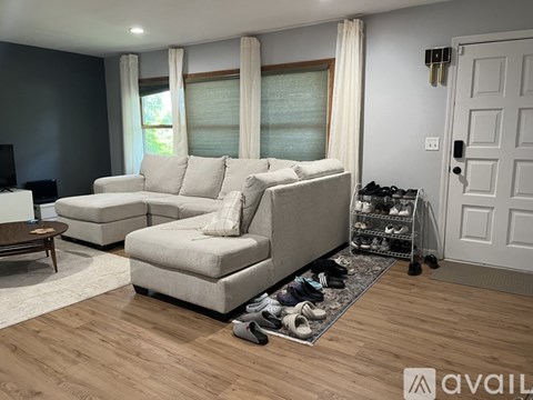 A living room with a white sofa and a coffee table.