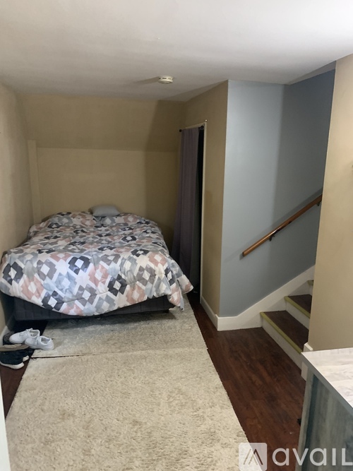 A bedroom with a bed and a carpet.