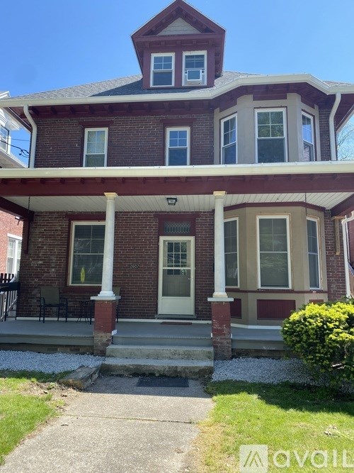 A house with a red brick facade and a white door.