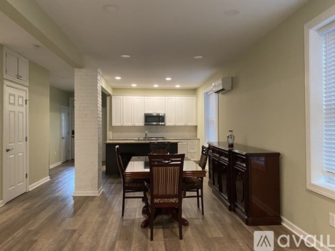 A dining room with a wooden table and chairs.