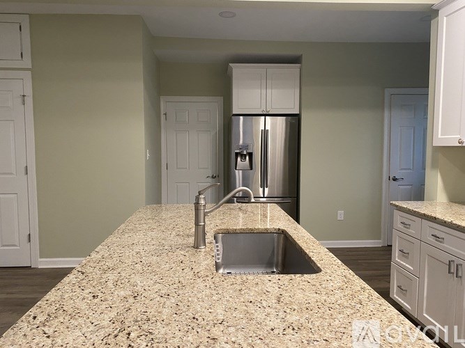 A kitchen with granite countertops and stainless steel appliances.