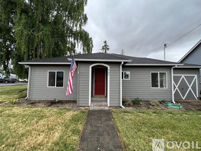 A house with a red door and an American flag hanging on it.