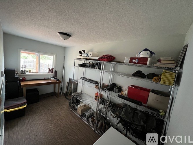 A room with a lot of shelves and a table.