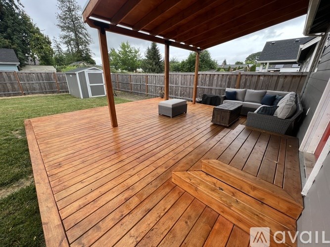 A wooden deck with a bench and a table.
