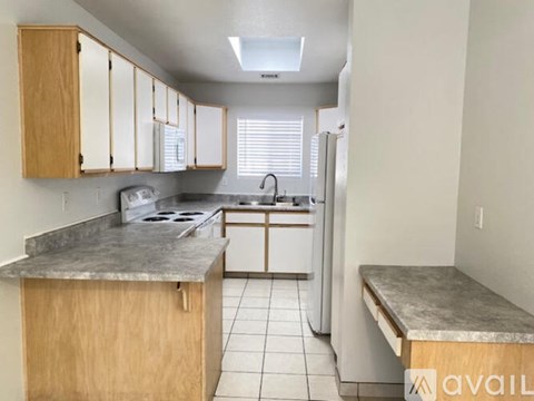 A kitchen with wooden cabinets and a marble countertop.