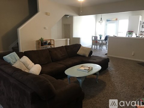 A living room with a brown couch and a blue coffee table.