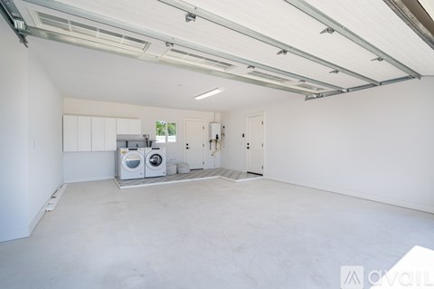 A spacious garage with a concrete floor and white walls.