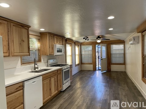 A kitchen with wooden cabinets and a white countertop.