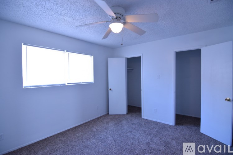 A room with a ceiling fan and a window.