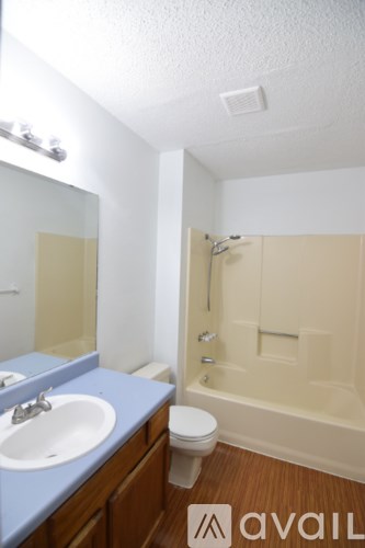 A bathroom with a sink, toilet and bathtub.