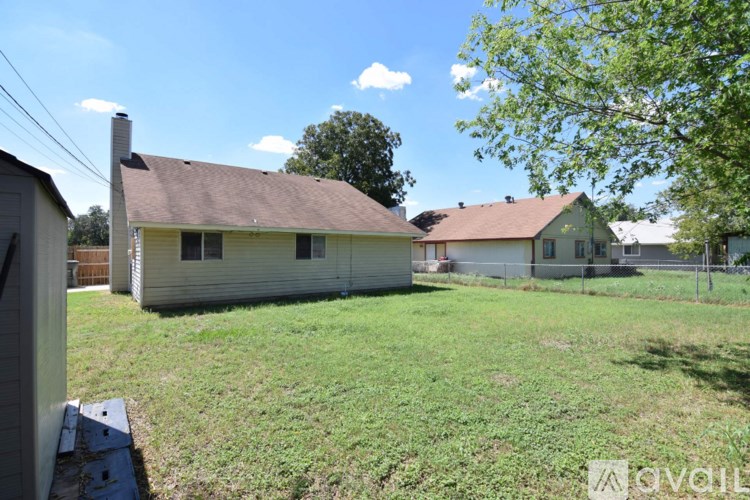 A house with a brown roof and a white house with a red roof in the background.