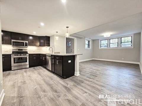 A spacious kitchen with dark wood cabinets and a central island.