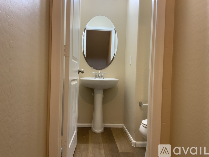 A bathroom with a sink, mirror, and toilet.