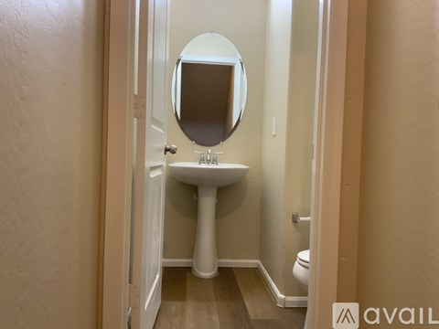 A bathroom with a sink, mirror, and toilet.