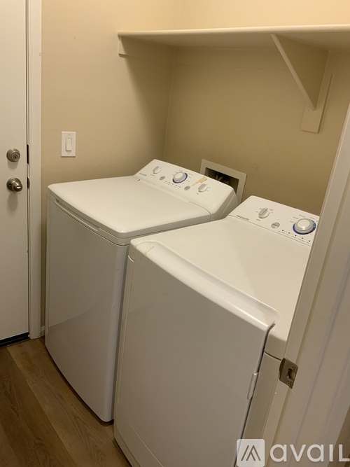 Two washing machines in a small room.