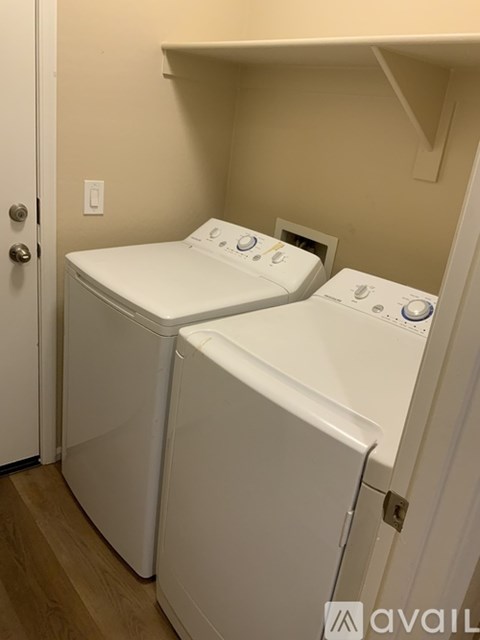 Two washing machines in a small room.