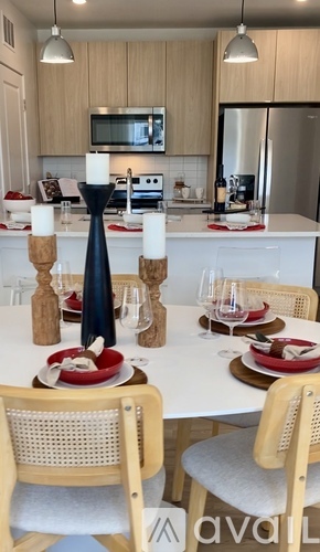 A kitchen with a table set for a meal.