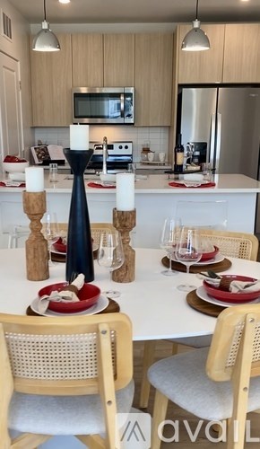 A kitchen with a table set for a meal.