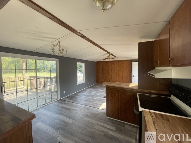 A kitchen with wooden cabinets and a stove top oven.