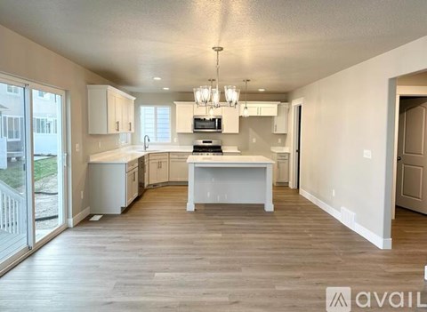 A spacious kitchen with white cabinets and a central island.