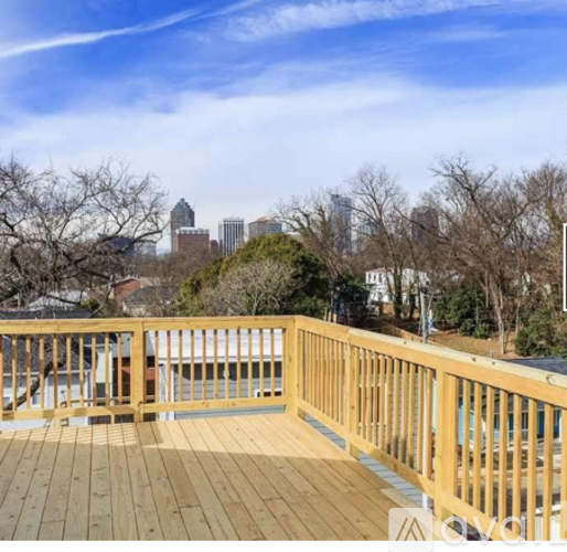 A wooden deck overlooks a city skyline.