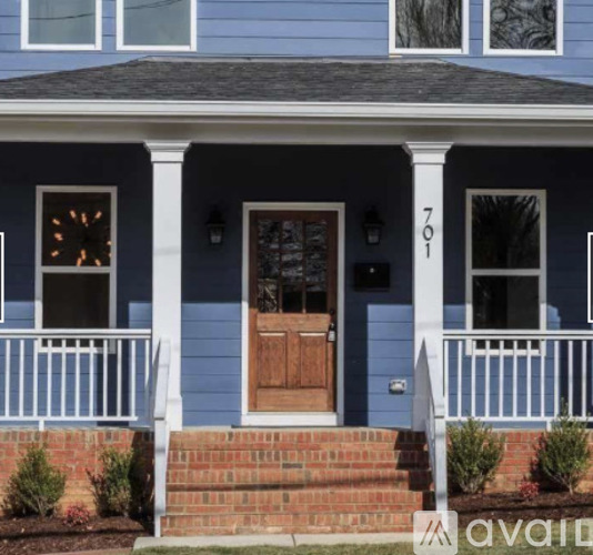 A blue house with a wooden door and windows.