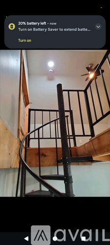 A staircase with a black railing and wooden steps.