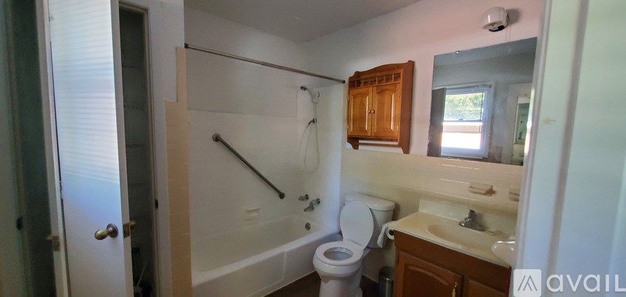 A bathroom with a toilet, sink, and bathtub.