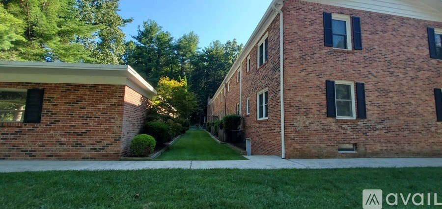 A brick building with a green lawn in front.