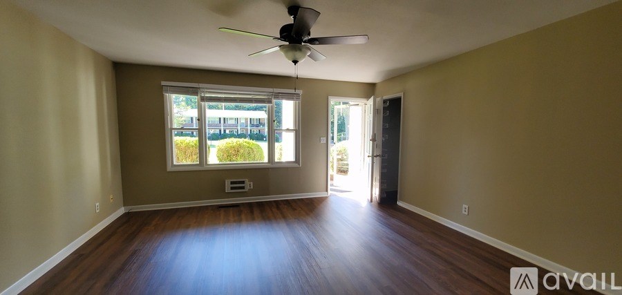 A room with a ceiling fan and a window.
