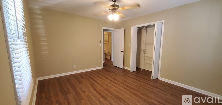 A room with wooden floors and a ceiling fan.