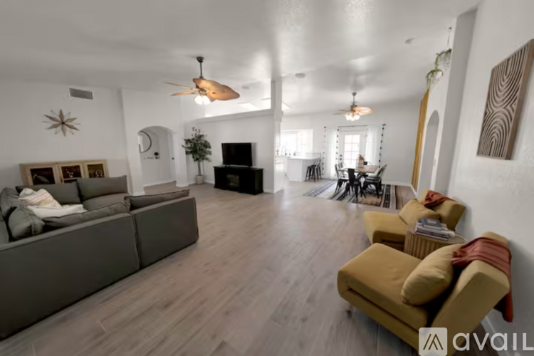 A living room with a grey couch and a yellow chair.