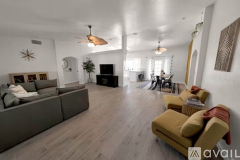 A living room with a grey couch and a yellow chair.
