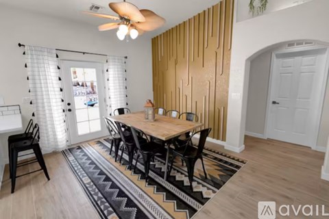 A dining room with a wooden table and chairs.