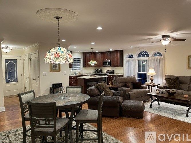 A living room with a round table and chairs.