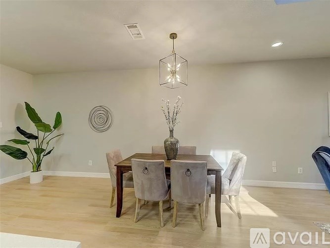 A dining room with a wooden table and chairs.