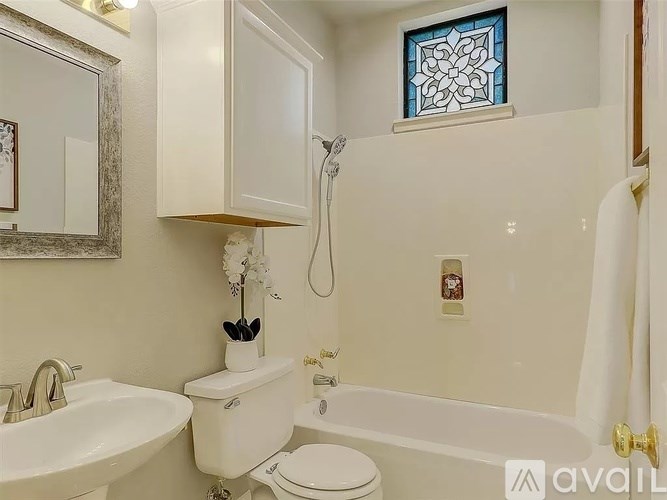 A white bathroom with a sink, toilet, and bathtub.