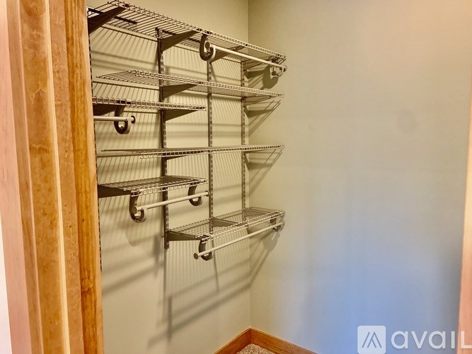 A wall-mounted shelving unit with multiple shelves and wheels.