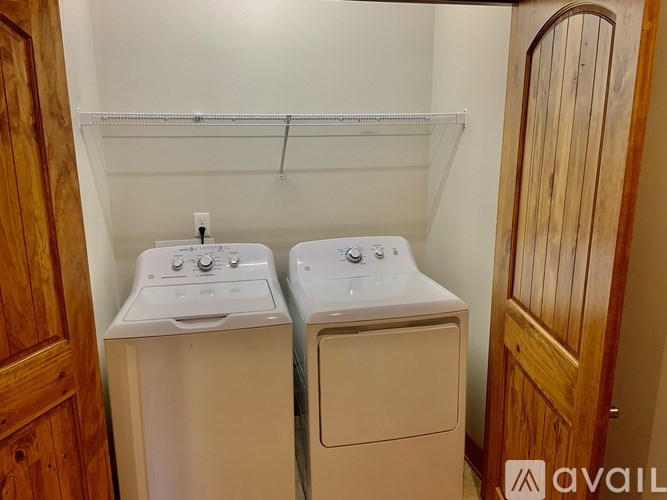 A small laundry room with a washer and dryer.