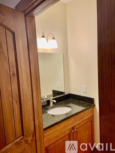 A bathroom with a sink and mirror.