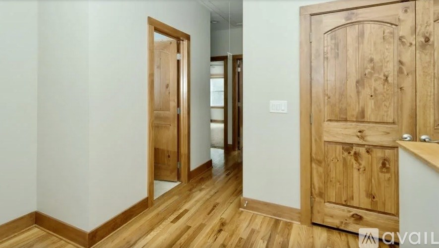 A room with wooden floors and a wooden door.
