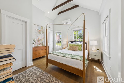A bedroom with a large bed and a window.