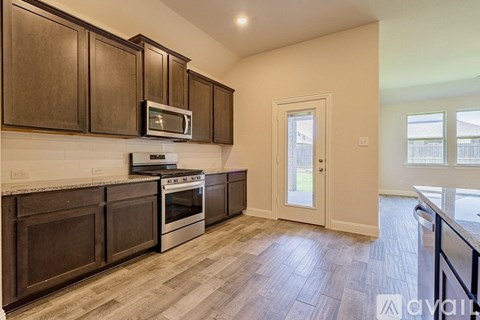 A kitchen with wooden cabinets and a white oven.