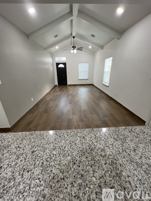A room with a carpeted floor and a wooden floor.