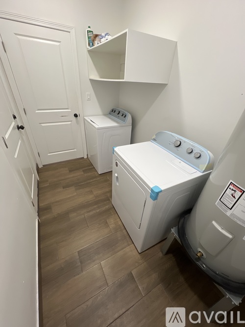A small laundry room with a washer and dryer.