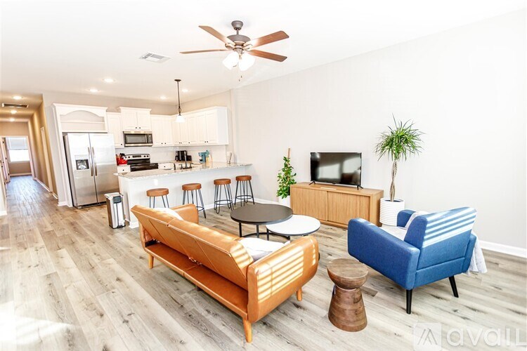A living room with a blue couch and a wooden coffee table.